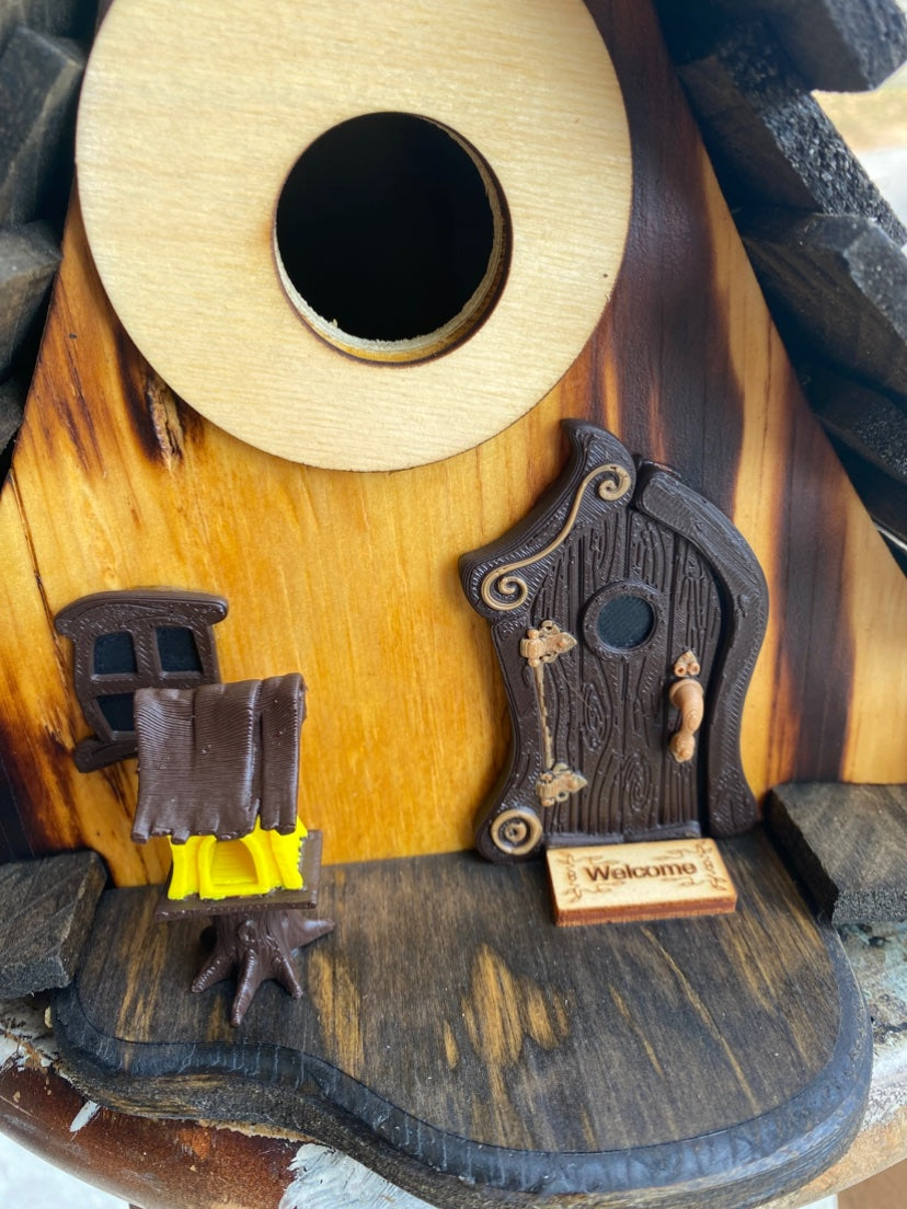 Close-up of the arched door and porch detail on the Burned A-frame birdhouse