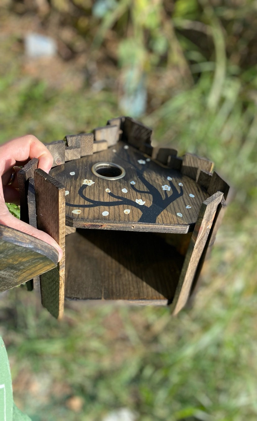 Cleanout bottom panel removed, showing the inside of the birdhouse