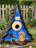 Rustic Blue A-frame birdhouse in a garden with a wooden fence