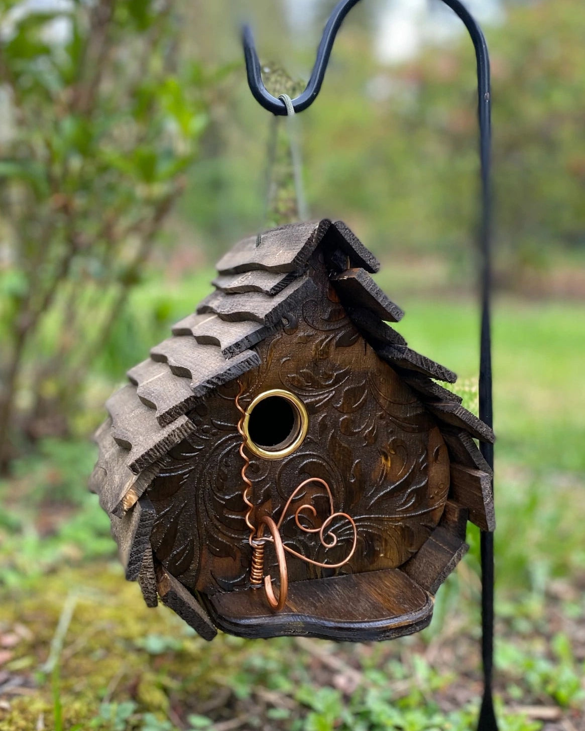 Stain Engraved Dome birdhouse hanging on a shepherd hook